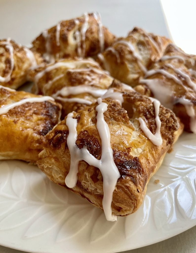 vanilla glaze drips onto the edges of these turnovers.