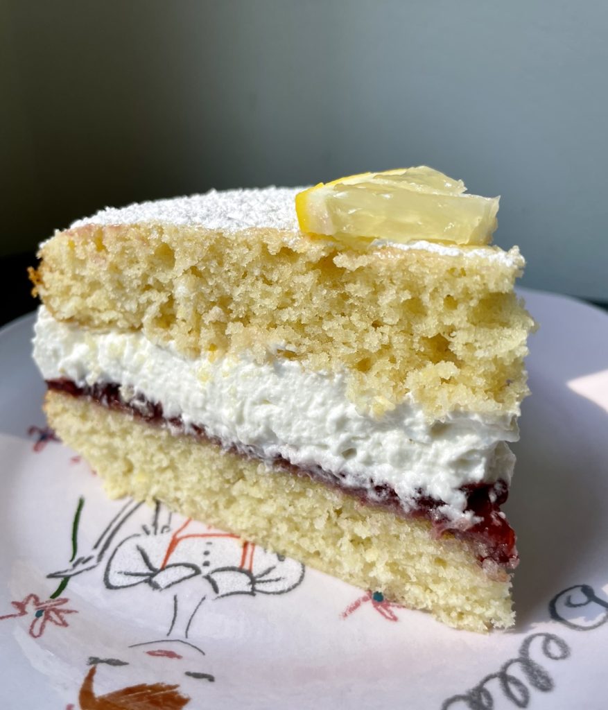 A slice of lemon victoria sponge cake.