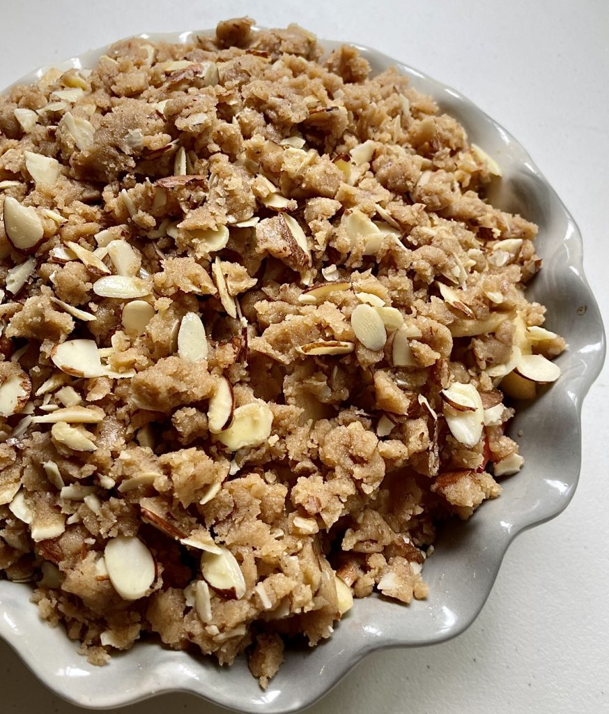 a close up of the crumbly, crisp topping on this apple strawberry crisp.