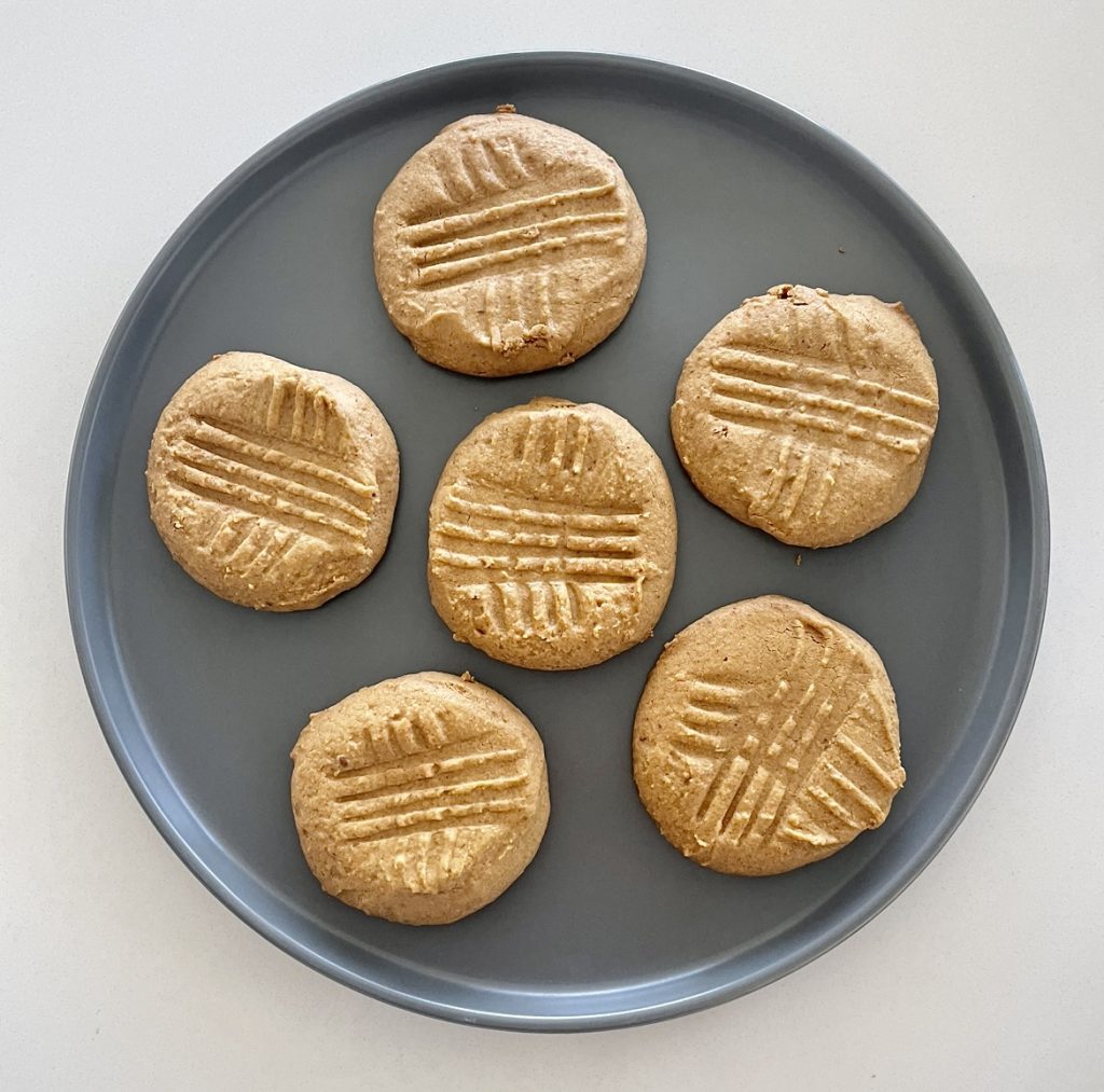 baked peanut butter cookies on a grey plate.