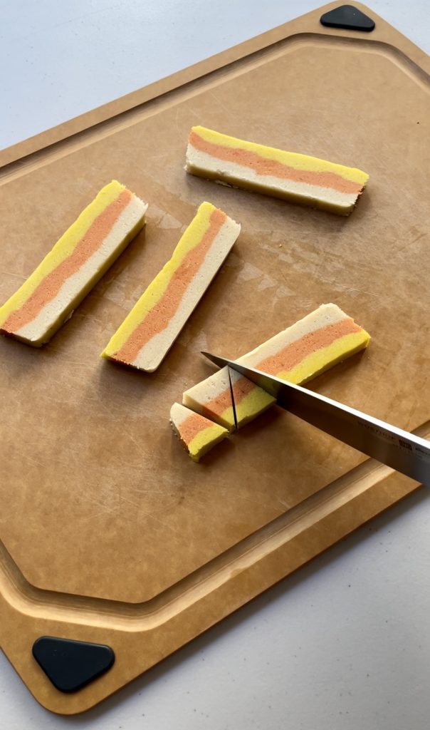 cutting each slice into wedges to form the shape of a candy corn.