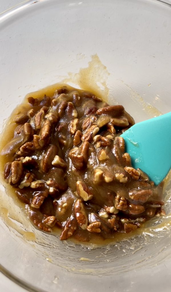 Combining butter, brown sugar, light corn syrup and pecans for the pecan topping.