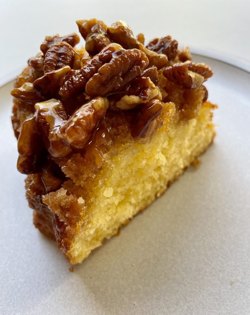 A slice of upside down pecan cake ready to be served.
