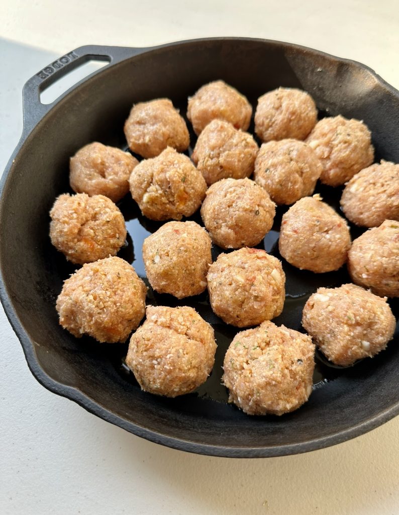 These healthy chicken parmesan meatballs fit perfectly in a cast iron pan!