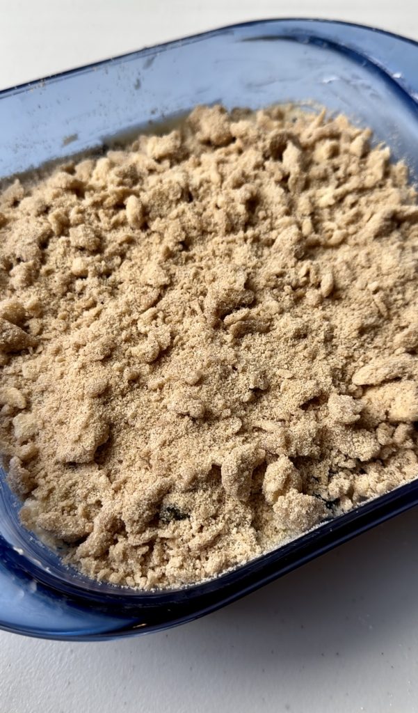 The streusel topping is dry and crumbly at first, but adheres to the cake once it's baked.