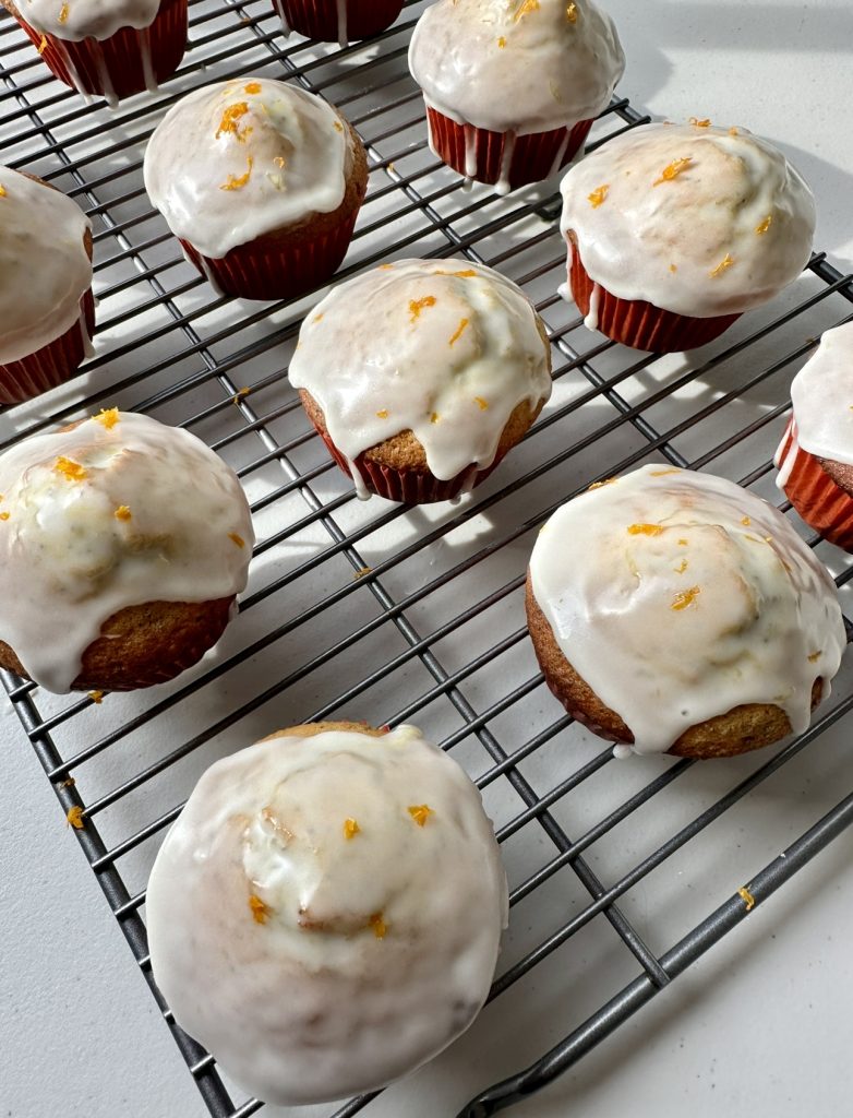 It's best to let the muffins cool before glazing them to prevent the glaze from melting off.