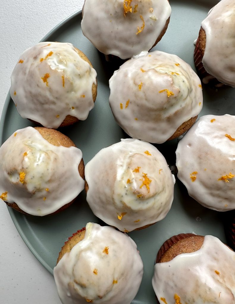 Orange poppyseed muffins are topped with an easy orange glaze and a little optional orange zest.