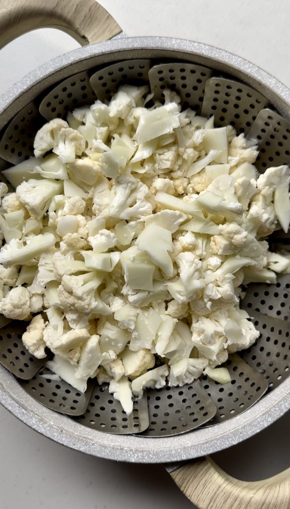 If you're using raw cauliflower, it's important to steam it until fork tender so it's easy to shape into patties later on.