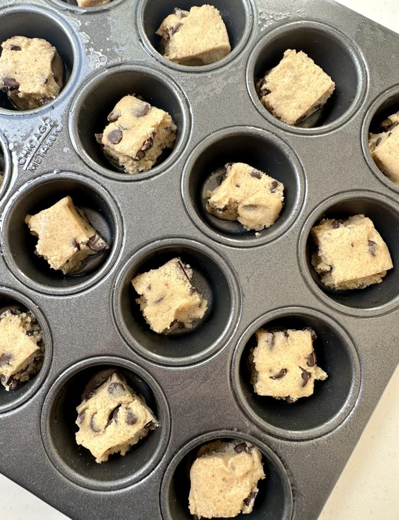 For the cookie cups, place 1 piece of cookie dough into each muffin tin cavity.