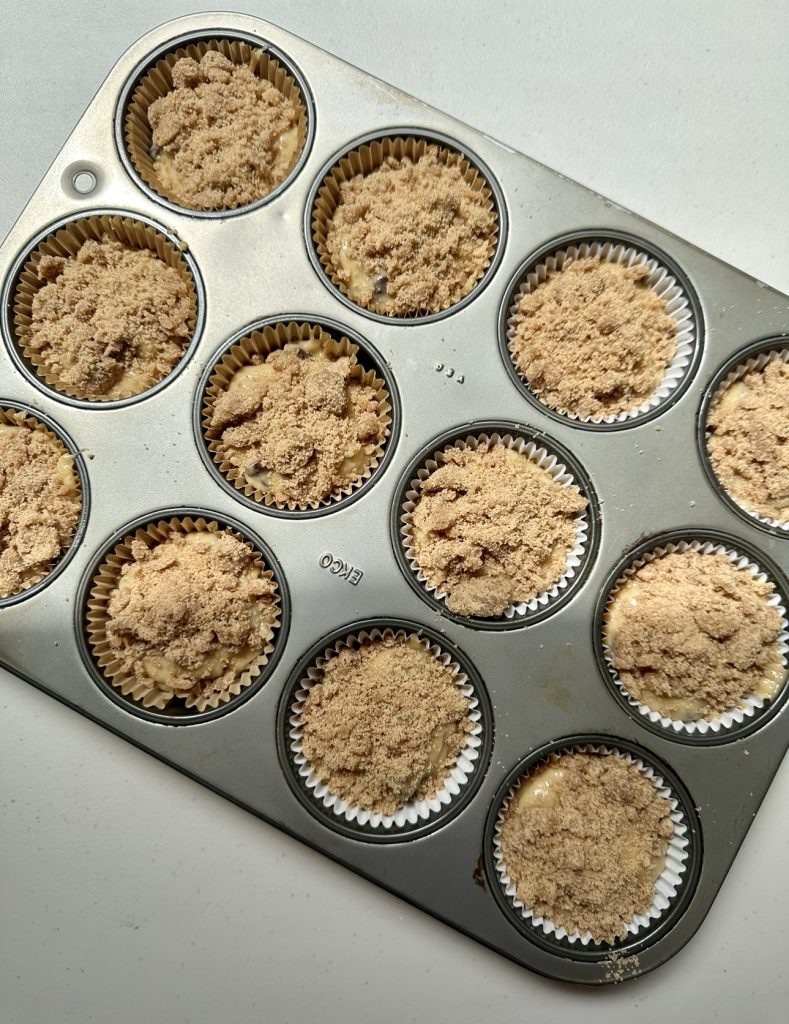 The quick streusel topping only takes 4 ingredients to make- sugar, flour, cinnamon and butter! It should initially be crumbly, then once it bakes it will "become one" with the muffins!